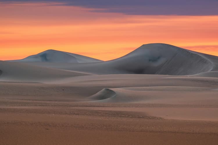 Sunset Over Desert Dunes