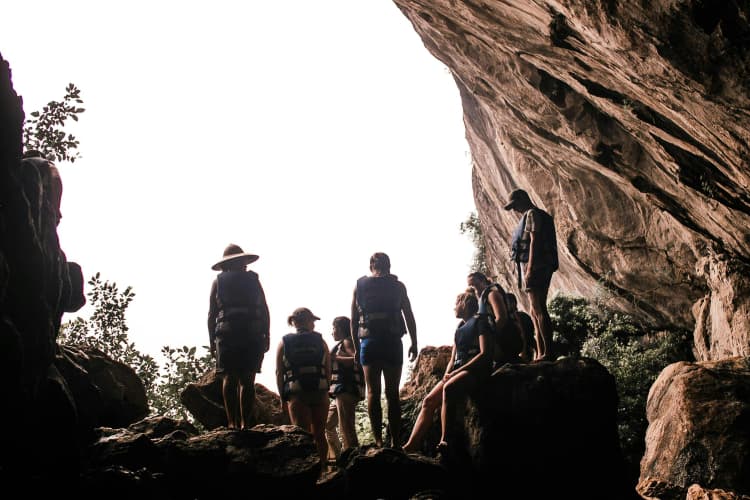 Hikers Explore Rocky Cave