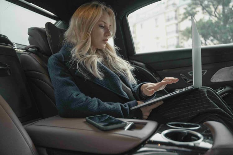 Blonde working in car