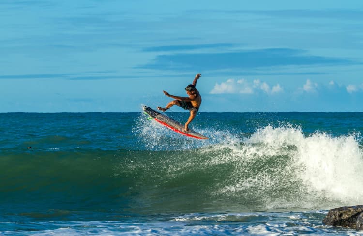 Surfer Catching Air Wave