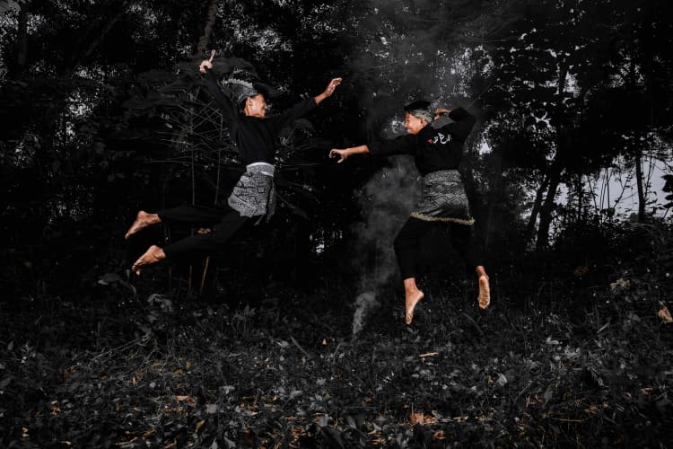 Dancers Leaping in Forest