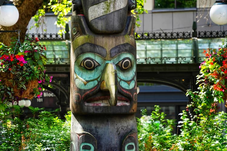 Native totem amid flowers